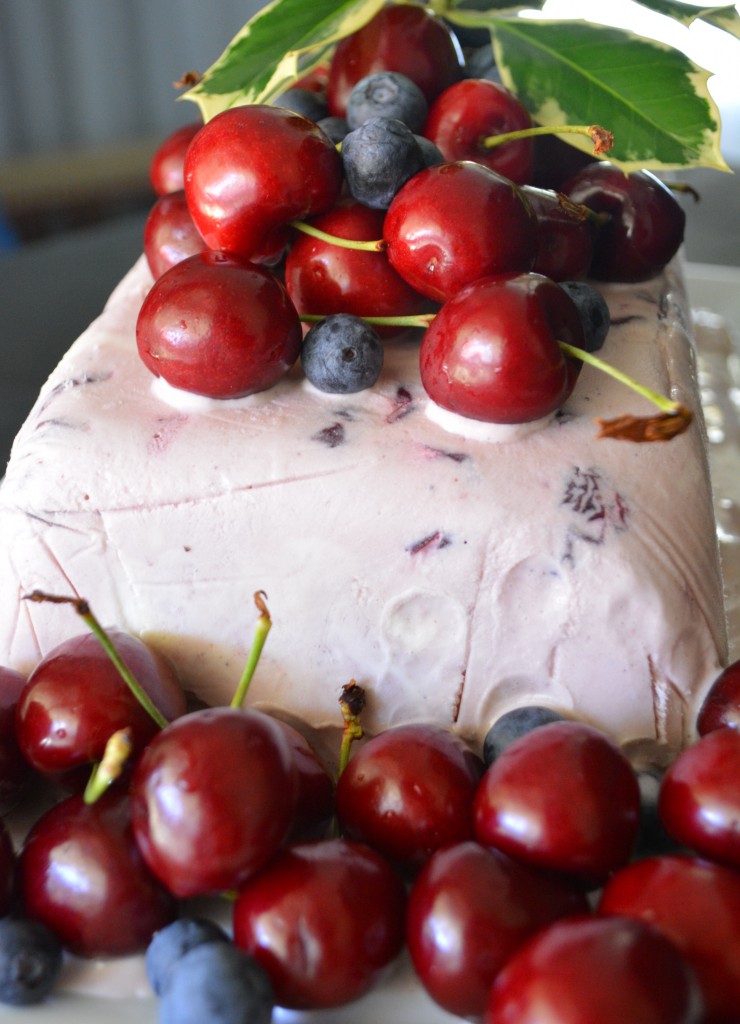 Christmas icecream cake with cherries, berries and holly