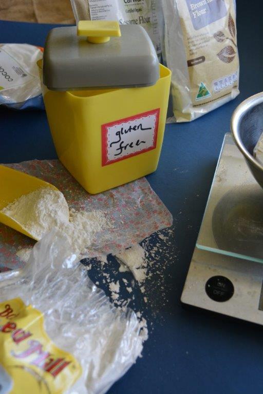 Yellow bakelite gluten-free flour canister with digital scales and Bob's Red Mill flour in foreground