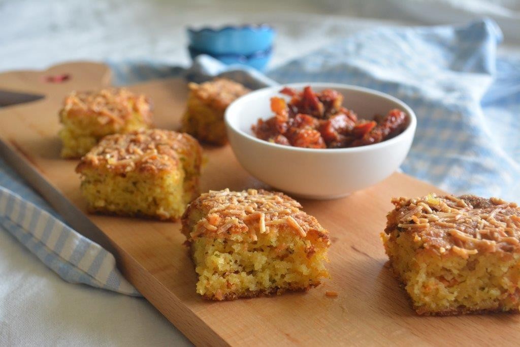 Gluten-free Italian style cornbread on wooden platter with tomato dipping sauce. Top 10 gluten-free lunchbox recipes