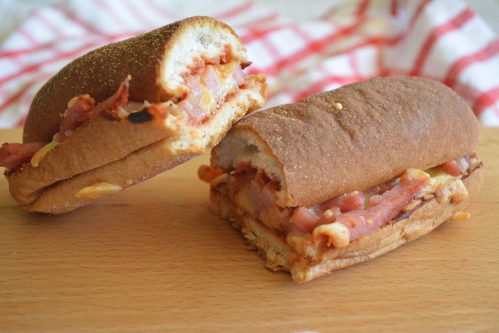 Gluten-free pizza sub with red and white checked cloth in background, representing GFL's top 5 fast-food inspired lunchtime recipes