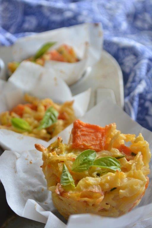 Gluten-free sweet potato and leek pasta bakes garnished with basil leaves, with blue tea towel in background. Top 10 gluten-free lunch recipes