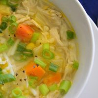 Bowl of gluten-free chicken vegetable soup with noodles